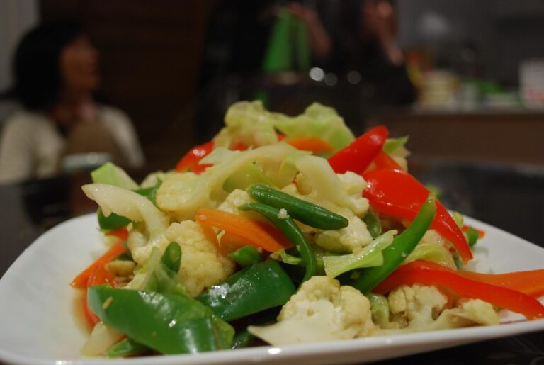 Stir-fry de legumes coloridos e crocantes no prato branco